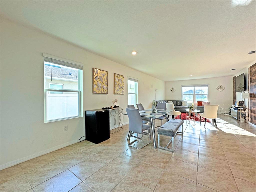 6988 Botanic Boulevard Harmony, FL 34773 - Photo 15 of 61 a living room with furniture and a window