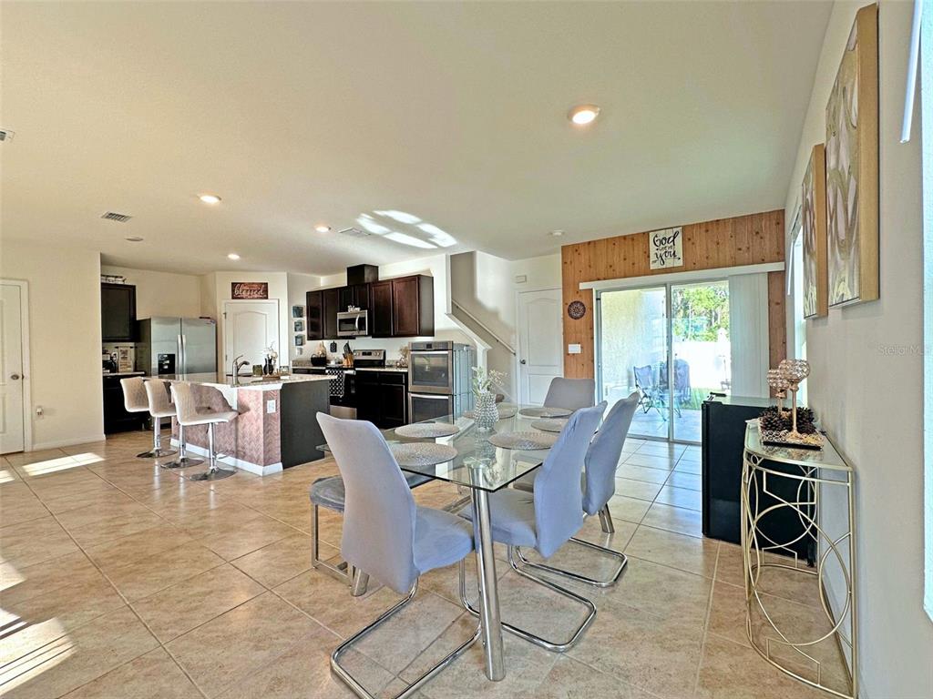 6988 Botanic Boulevard Harmony, FL 34773 - Photo 16 of 61 a view of a dining room with furniture