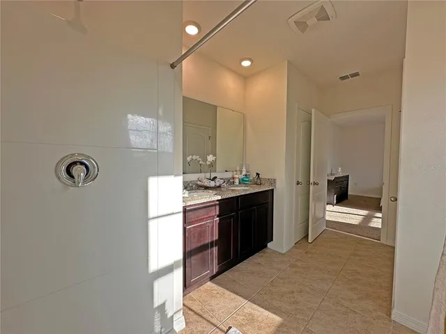 a bedroom with two beds and a couch