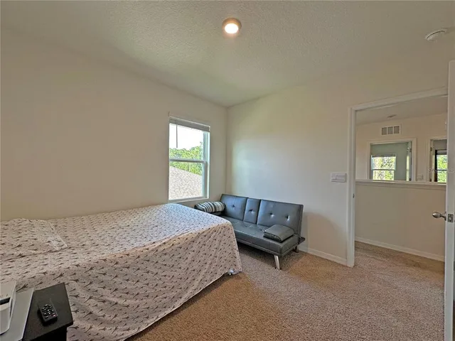 a bedroom with a bed and a table in it