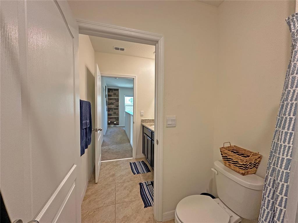 6988 Botanic Boulevard Harmony, FL 34773 - Photo 30 of 61 a bathroom with a toilet and a shower