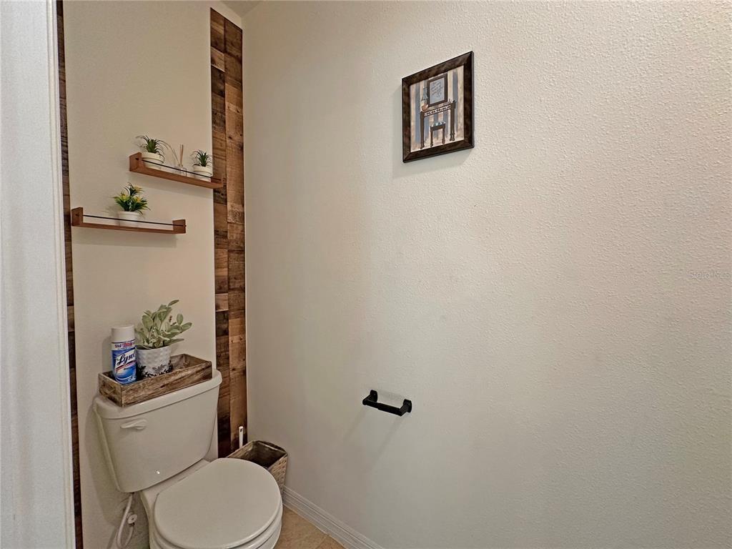 6988 Botanic Boulevard Harmony, FL 34773 - Photo 36 of 61 a white toilet sitting next to a bathroom sink