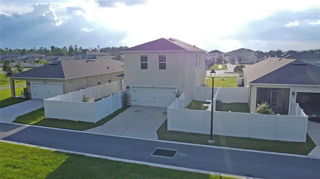 a aerial view of a house with garden space and patio