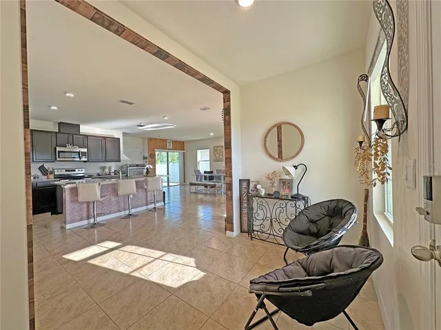 a kitchen with stainless steel appliances granite countertop a sink a stove and a wooden floors