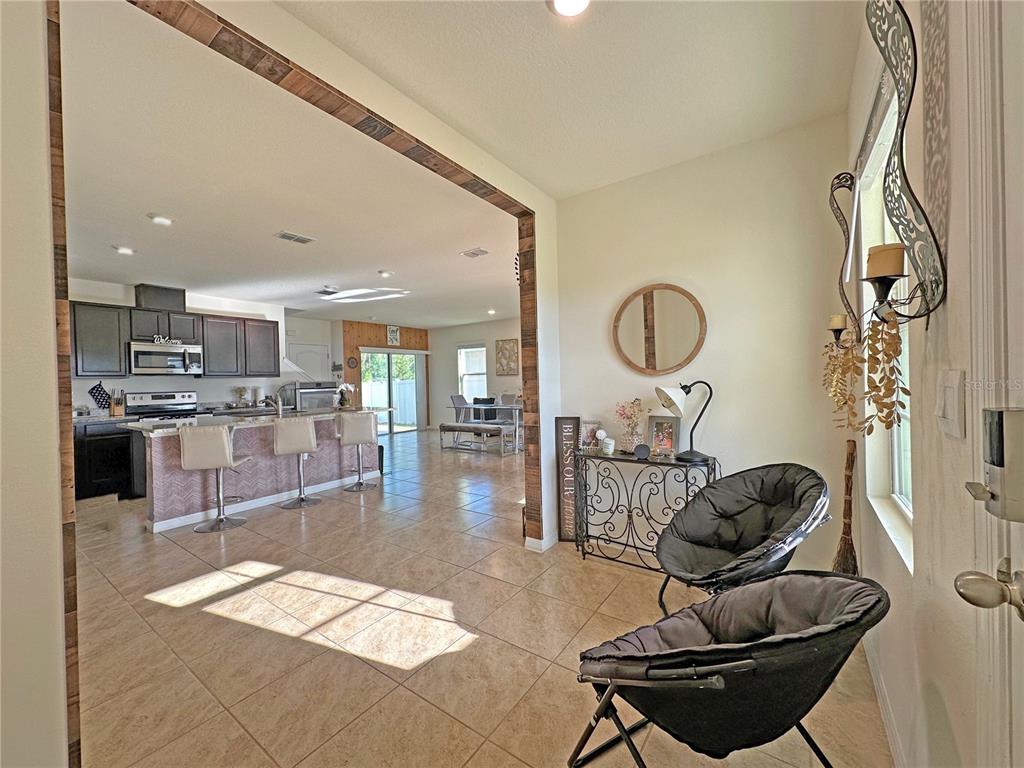 6988 Botanic Boulevard Harmony, FL 34773 - Photo 7 of 61 a lobby with furniture and rug
