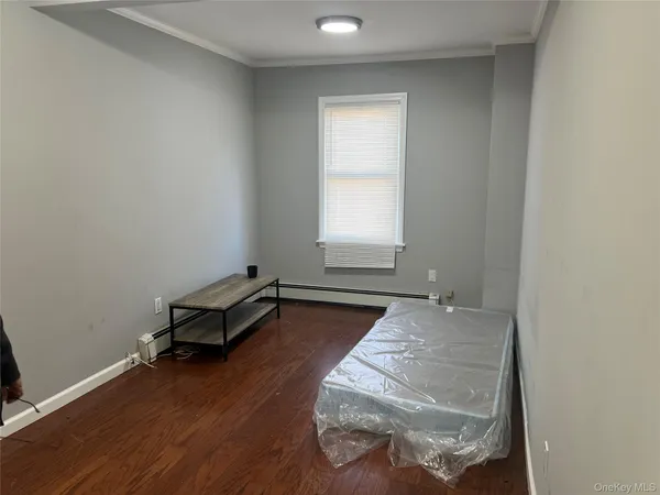 a room with exposed pipes and a window