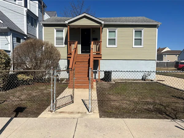 a view of a house with wooden fence