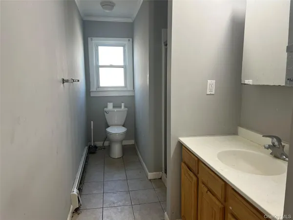 a bathroom with a sink toilet and a mirror