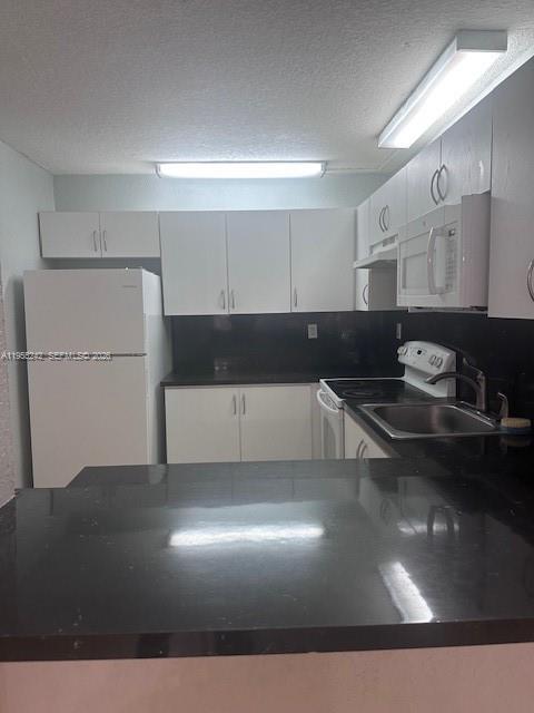 180 Royal Palm Road, Unit 111 Hialeah Gardens, FL 33016 - Photo 3 of 6 a living room with stainless steel appliances furniture and a kitchen view