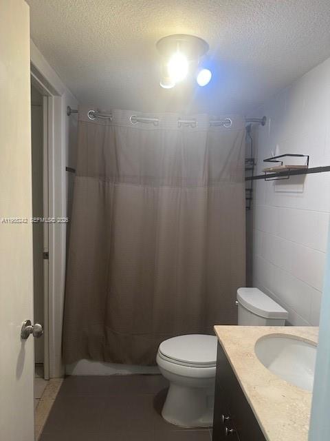 180 Royal Palm Road, Unit 111 Hialeah Gardens, FL 33016 - Photo 4 of 6 a white toilet sitting next to a bathroom sink and vanity