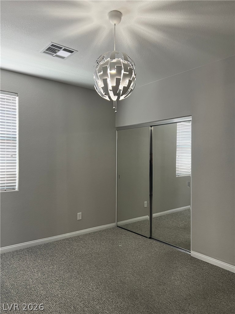 5981 Honeysuckle Ridge Street Las Vegas, NV 89148 - Photo 21 of 29 Modern pendant lighting illuminates a cozy, carpeted interior with ample closet space.