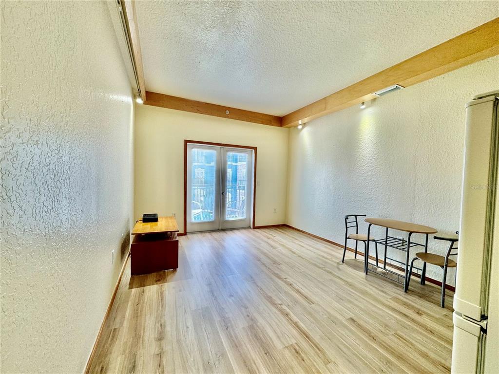 101 Palm Harbor Parkway, Unit C328 Palm Coast, FL 32137 - Photo 2 of 7 a view of empty room with wooden floor