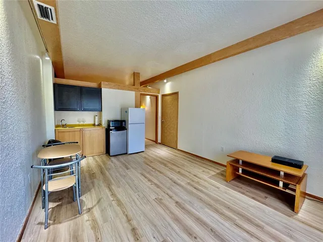a room with wooden floor and furniture