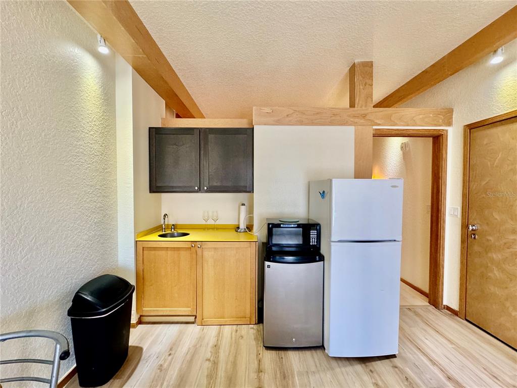 101 Palm Harbor Parkway, Unit C328 Palm Coast, FL 32137 - Photo 4 of 7 a kitchen with a refrigerator and a stove