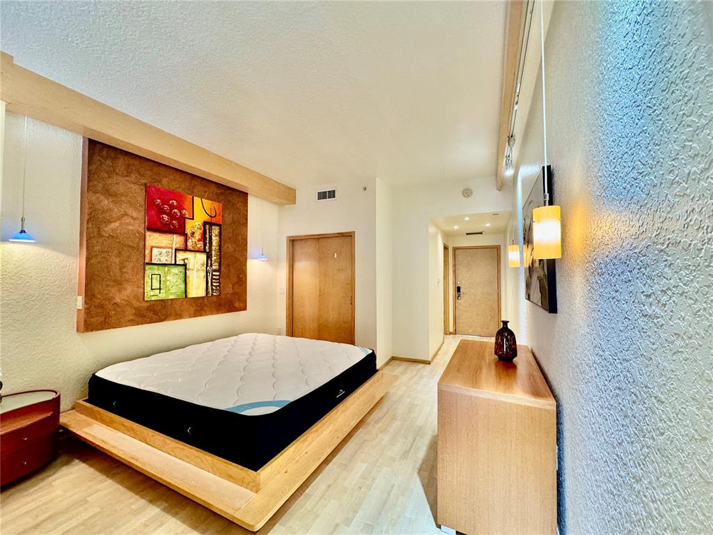 101 Palm Harbor Parkway, Unit C328 Palm Coast, FL 32137 - Photo 5 of 7 a bedroom with a bed and a table in it