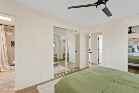 a spacious bedroom with a bed and a glass door shower