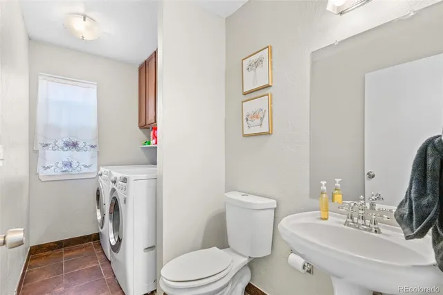 a white toilet sitting next to a bathroom sink