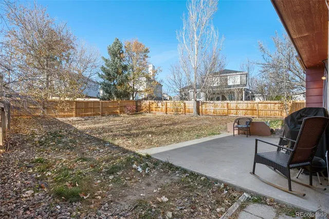 a view of a backyard with sitting area