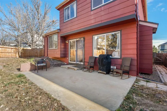 a view of a dinning tables and chairs in backyard of the house