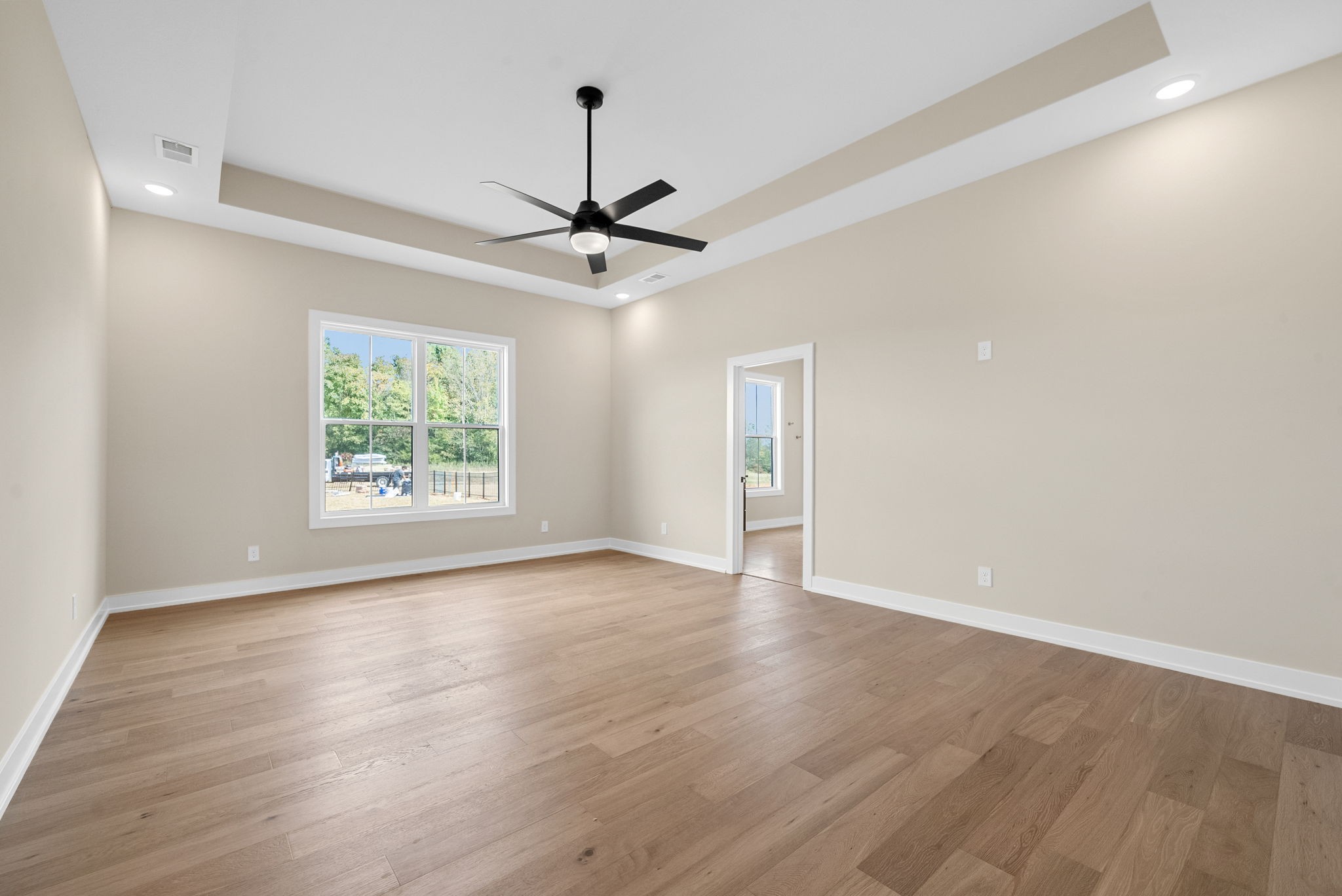 3712 Budds Creek Road Palmyra, TN 37142 - Photo 16 of 100 an empty room with wooden floor ceiling fan and windows