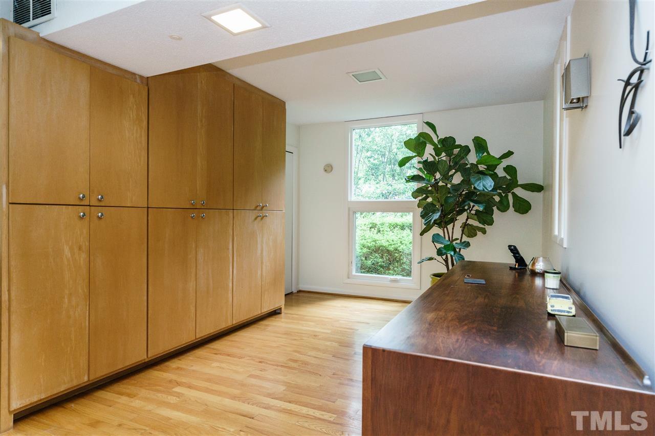 3606 Swann Street Raleigh, NC 27612 - Photo 15 of 25 This bonus space, located right off the living room, has plenty of extra storage to help you keep the minimalist look in this modern showpiece of a home.