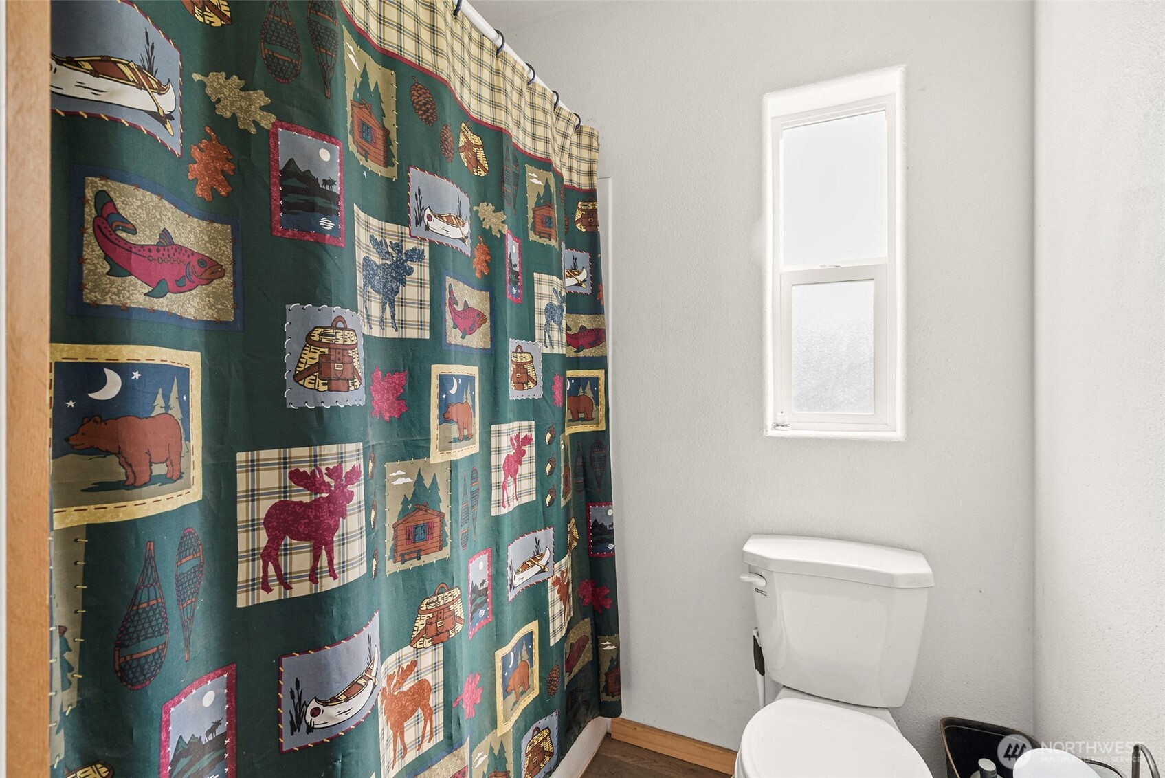 291 East Orchid Lane Grapeview, WA 98546 - Photo 12 of 37 a bathroom with a toilet and a shower curtain