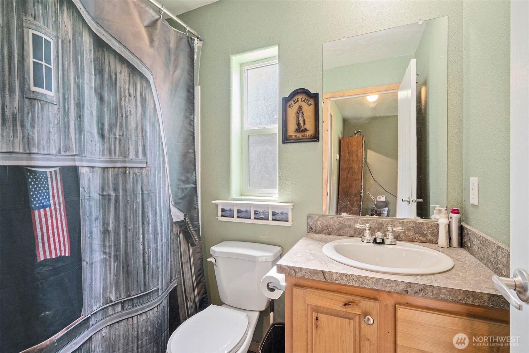 291 East Orchid Lane Grapeview, WA 98546 - Photo 15 of 37 a bathroom with a granite countertop sink mirror vanity and toilet