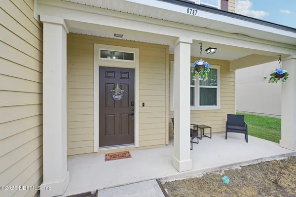 a living room with furniture flowerpot and window