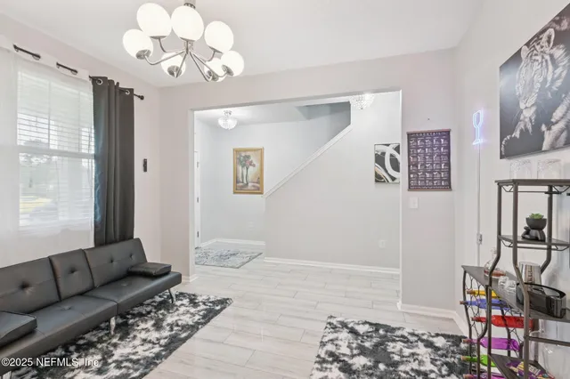 a view of a dining room with furniture large windows and wooden floor