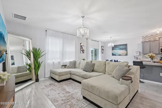 a open kitchen with stainless steel appliances kitchen island granite countertop a stove and a refrigerator
