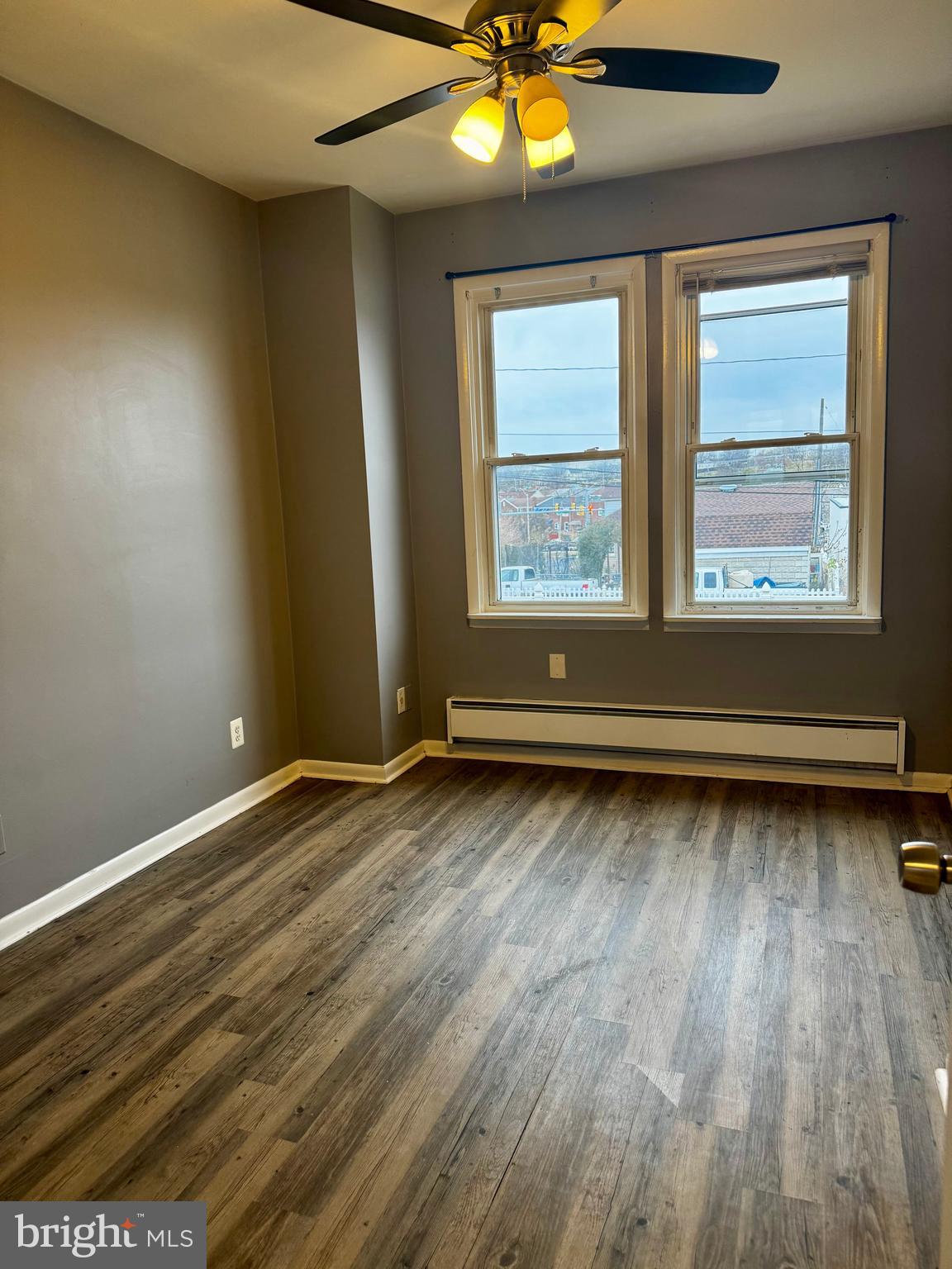 6604 O Donnell Street, Unit A Baltimore, MD 21224 - Photo 10 of 13 an empty room with wooden floor and windows