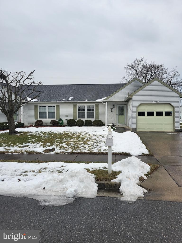 a view of a white house with a yard