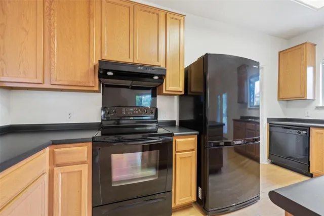 a kitchen with a stove and a refrigerator