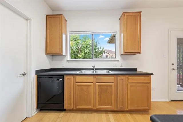 a view of a sink cabinets and a window