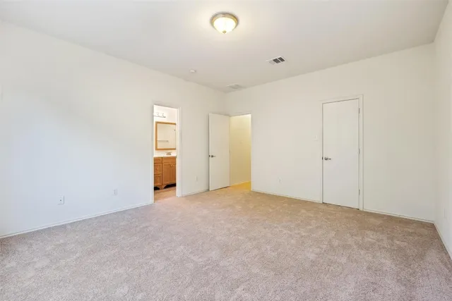 a bathroom with a granite countertop toilet sink and a mirror