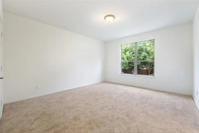 a bathroom with a sink a toilet and a large mirror