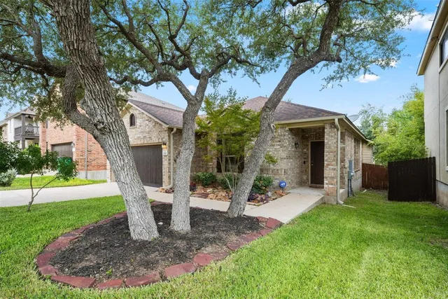 a view of a house with a tree in a yard