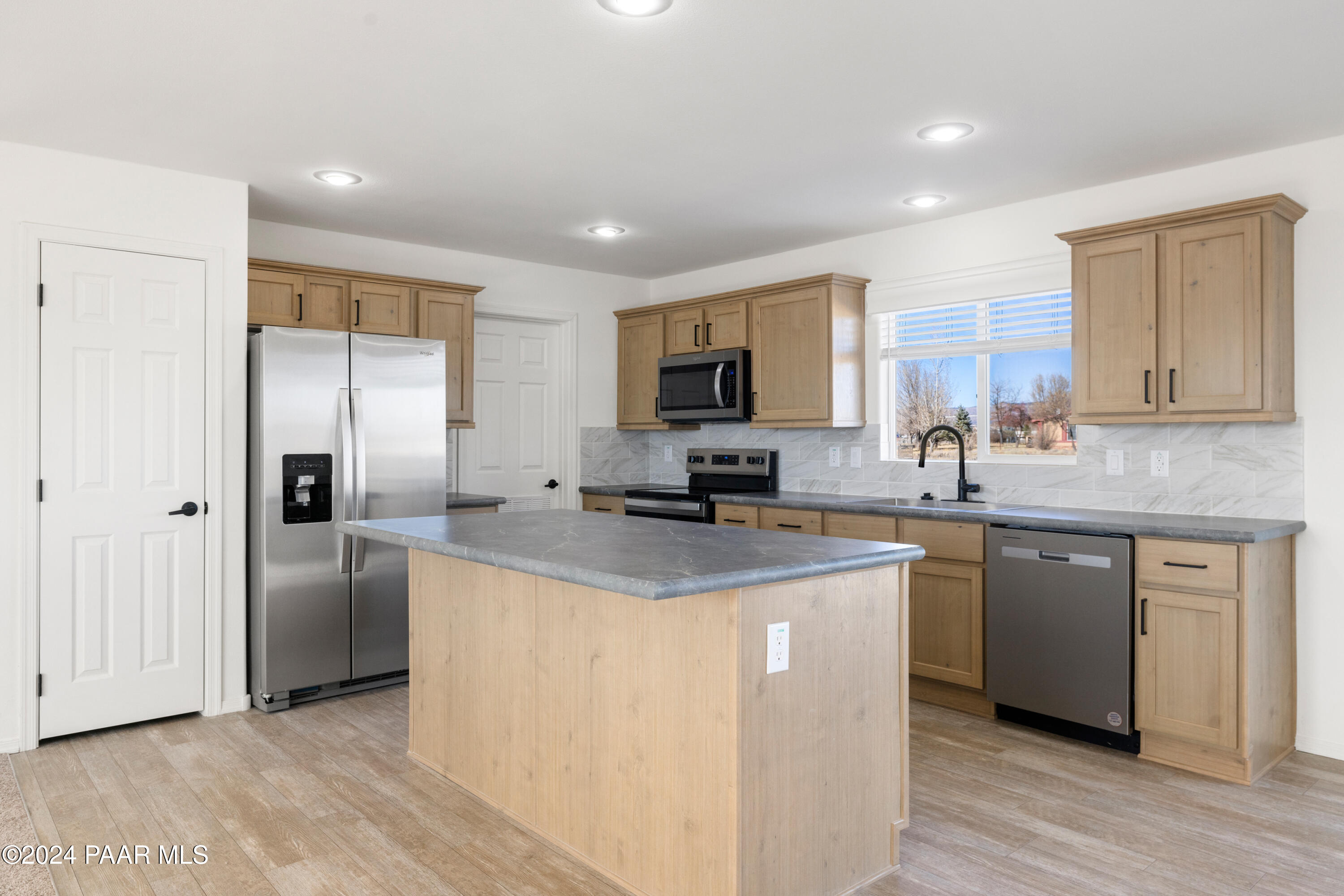 1460 Saddle Road Paulden, AZ 86334 - Photo 4 of 27 a kitchen with stainless steel appliances granite countertop a stove sink and refrigerator