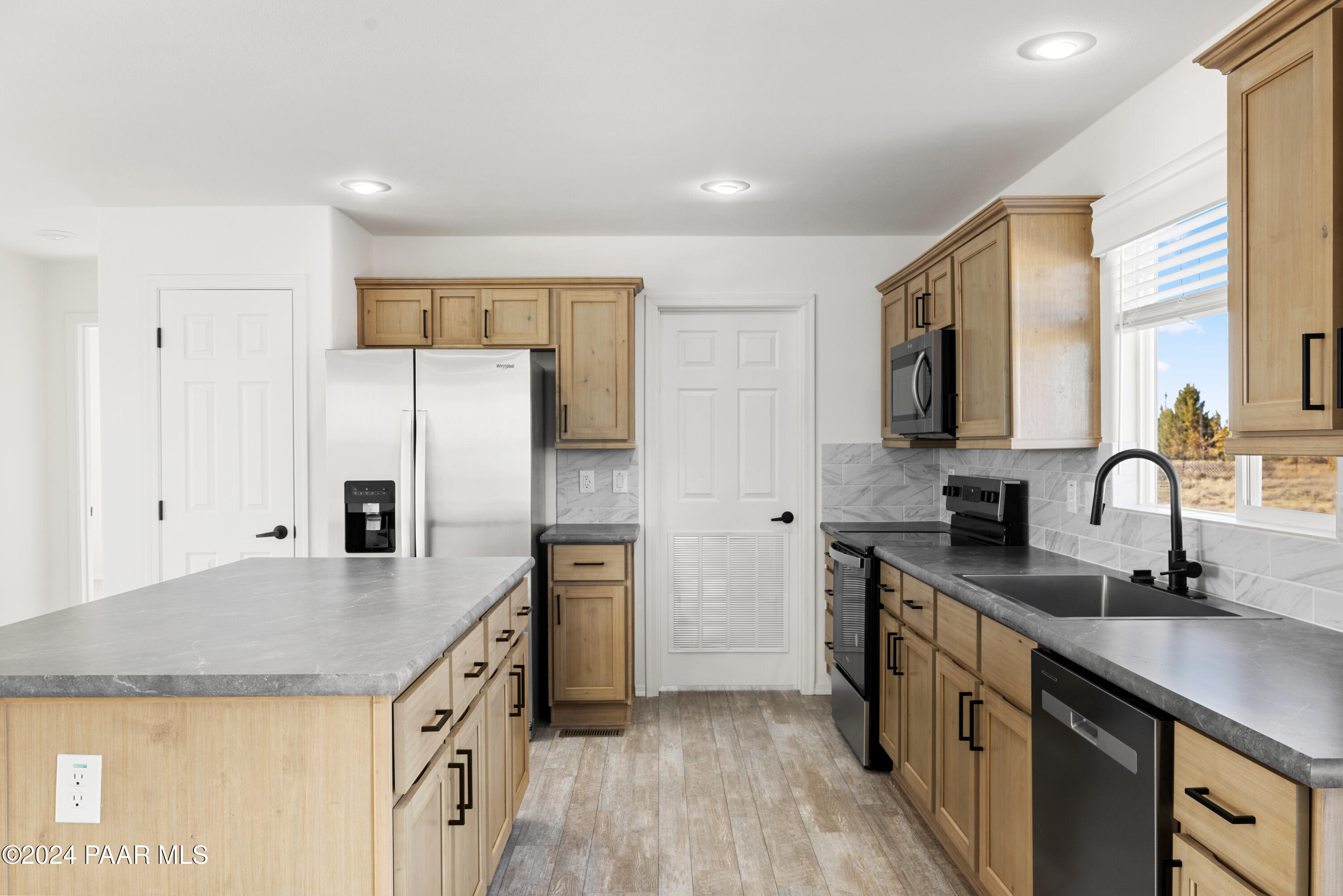 1460 Saddle Road Paulden, AZ 86334 - Photo 6 of 27 a kitchen with granite countertop a sink stove and refrigerator