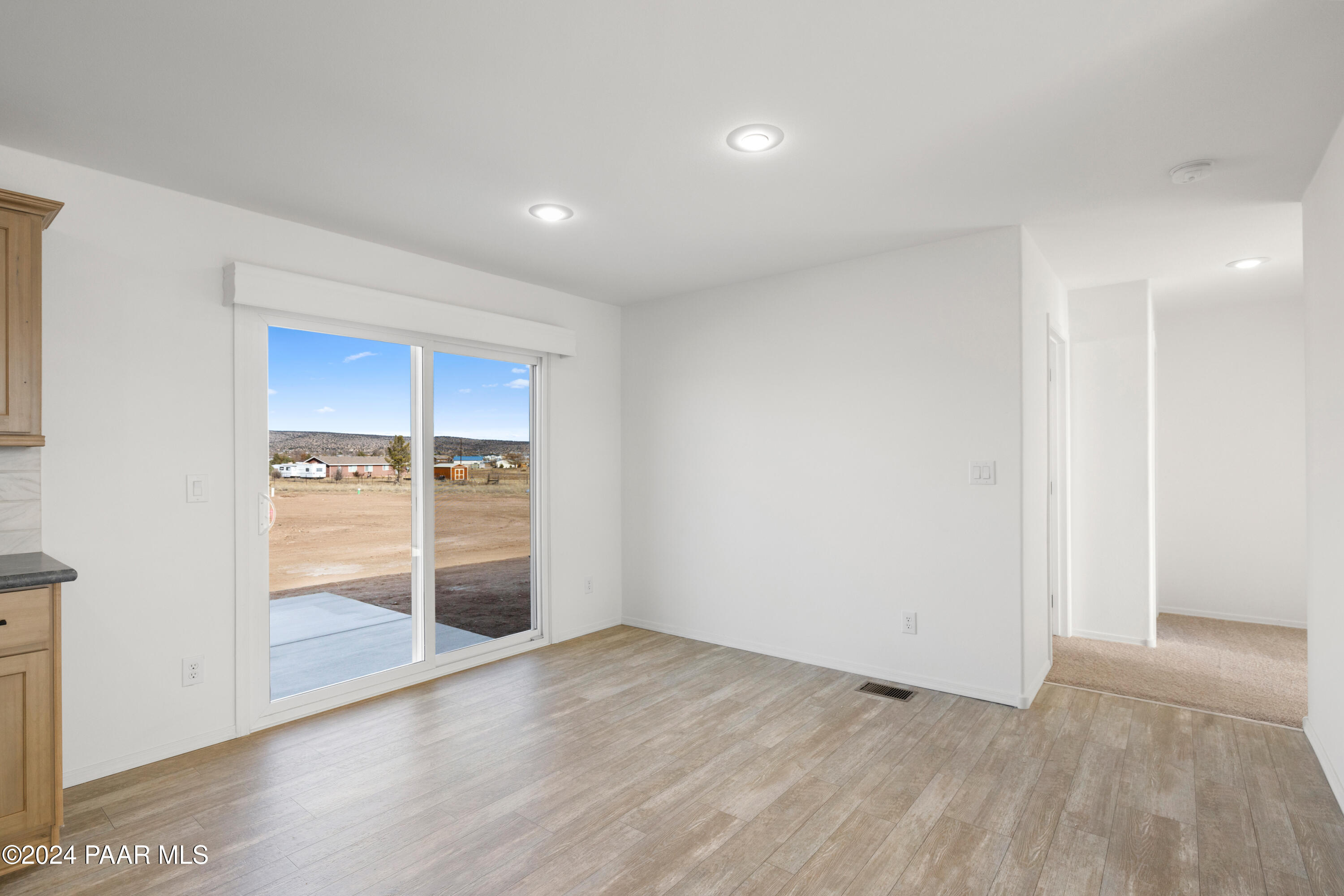 1460 Saddle Road Paulden, AZ 86334 - Photo 8 of 27 wooden floor in an empty room with a window