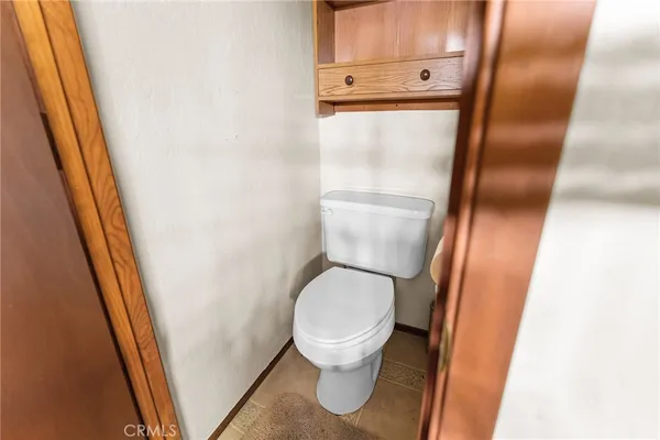 a white toilet sitting next to a sink