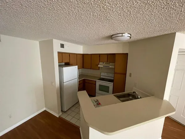 a kitchen with stainless steel appliances a refrigerator and a stove