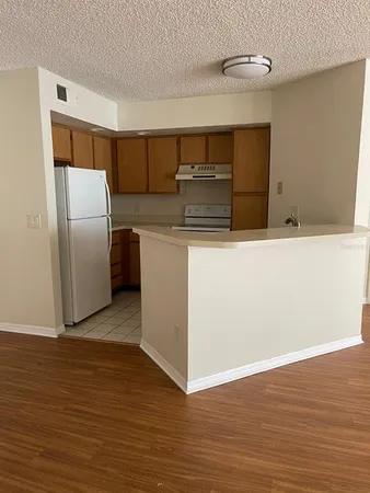 a kitchen with stainless steel appliances a refrigerator and a stove