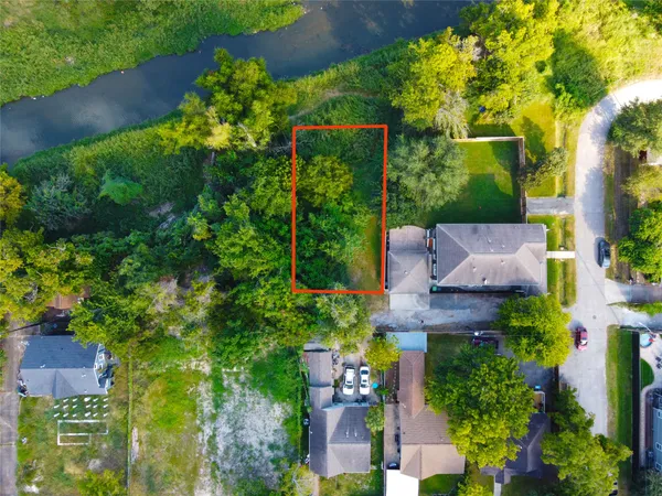 an aerial view of a house with garden space and street view