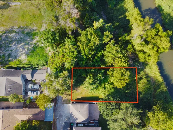 a backyard of a house with lots of green space and garden in the back
