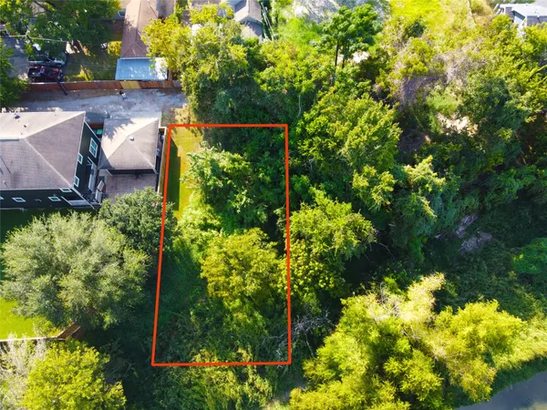 an aerial view of a house with a yard and garden