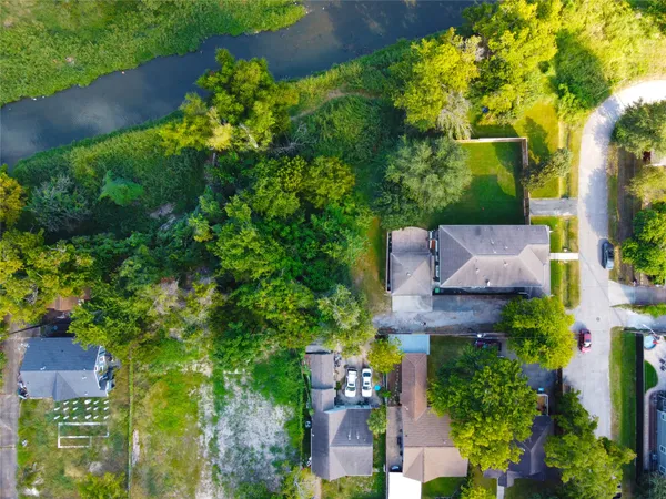 an aerial view of a house with a yard and garden