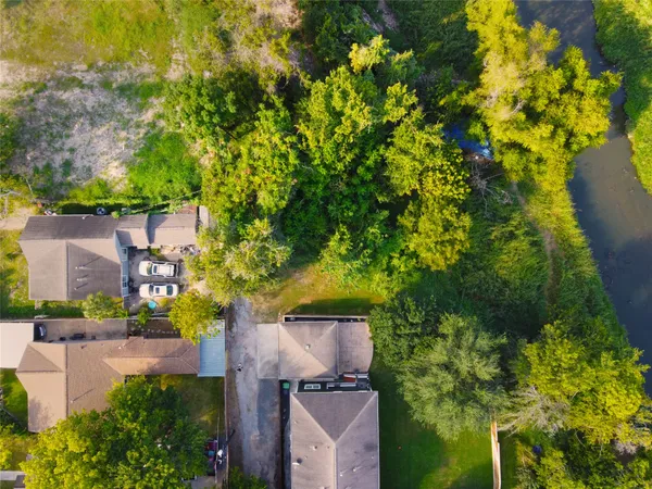 a backyard of a house with lots of green space and garden