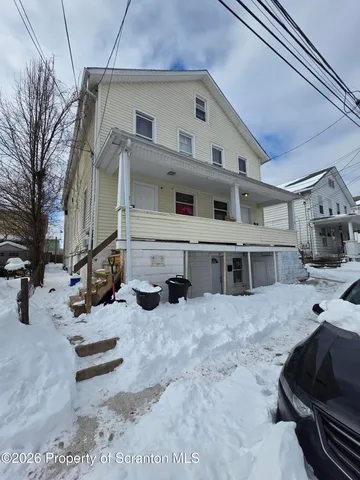 a view of a house with a snow in the yard