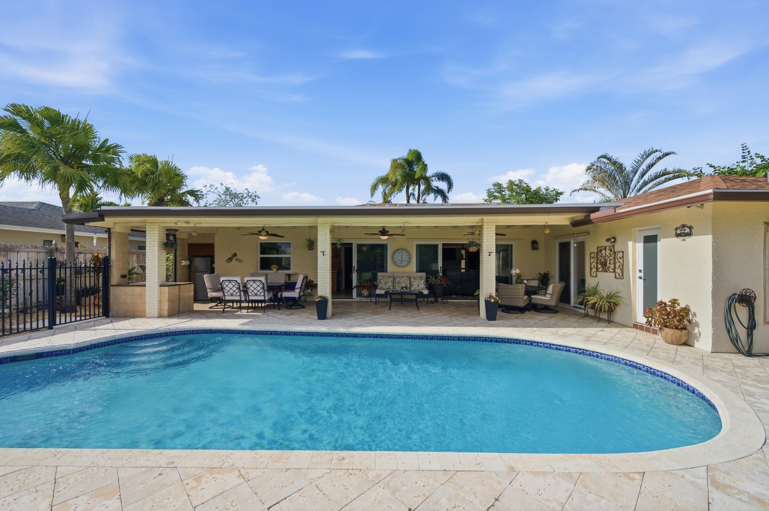 4780 Brandywine Drive Boca Raton, FL 33487 - Photo 31 of 43 a view of a house with swimming pool and sitting area
